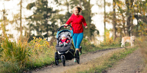 Woman running with a rented baby stroller from Equiply Spain.